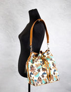 Dooney & Bourke Disney Medium Moana Coated Cotton Bucket Crossbody Bag Purse